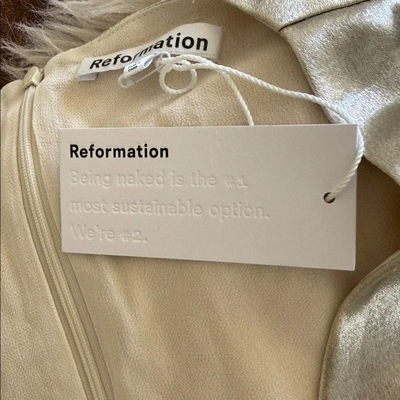 This is a Reformation Gatsby Dress in a silver or champagne color new with tags